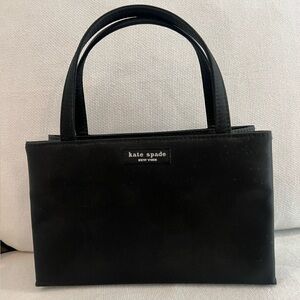 Kate Spade New York structured black satchel in a timeless silhouette.